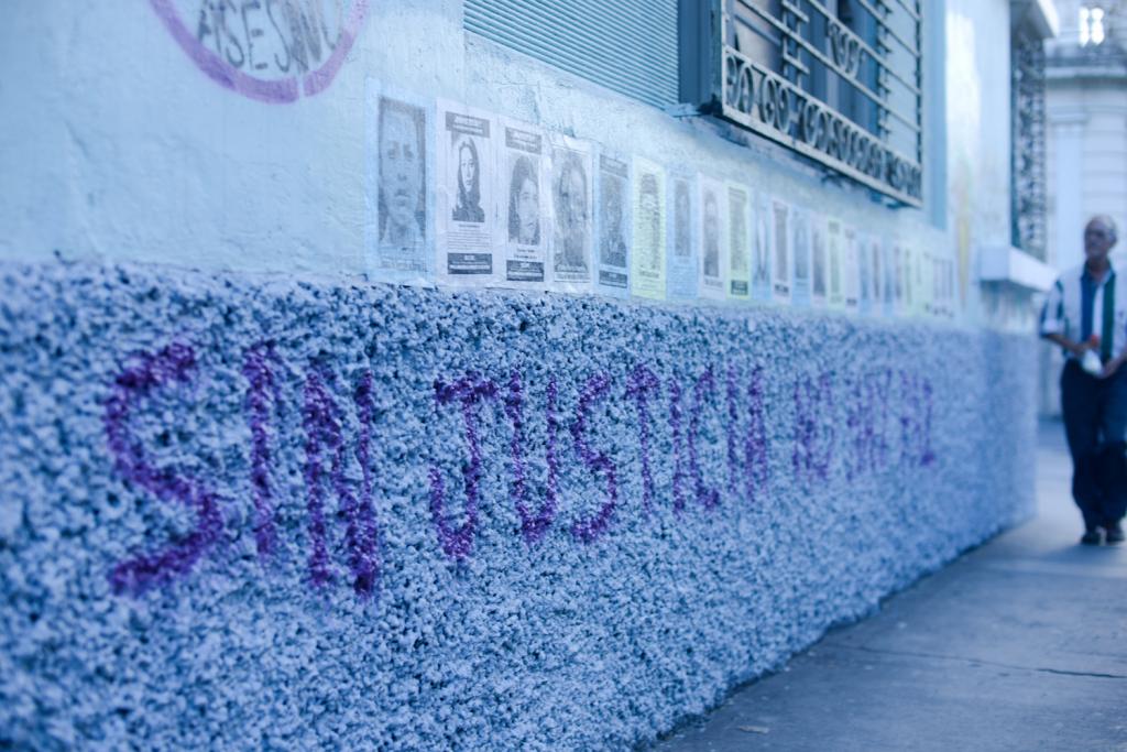 In the heart of Guatemala City, posters display the images of people who were ‘disappeared’ during the brutal civil war. The message “without justice, there is no peace” (translated from Spanish) is spray-painted below. Photography by Samer Muscati.