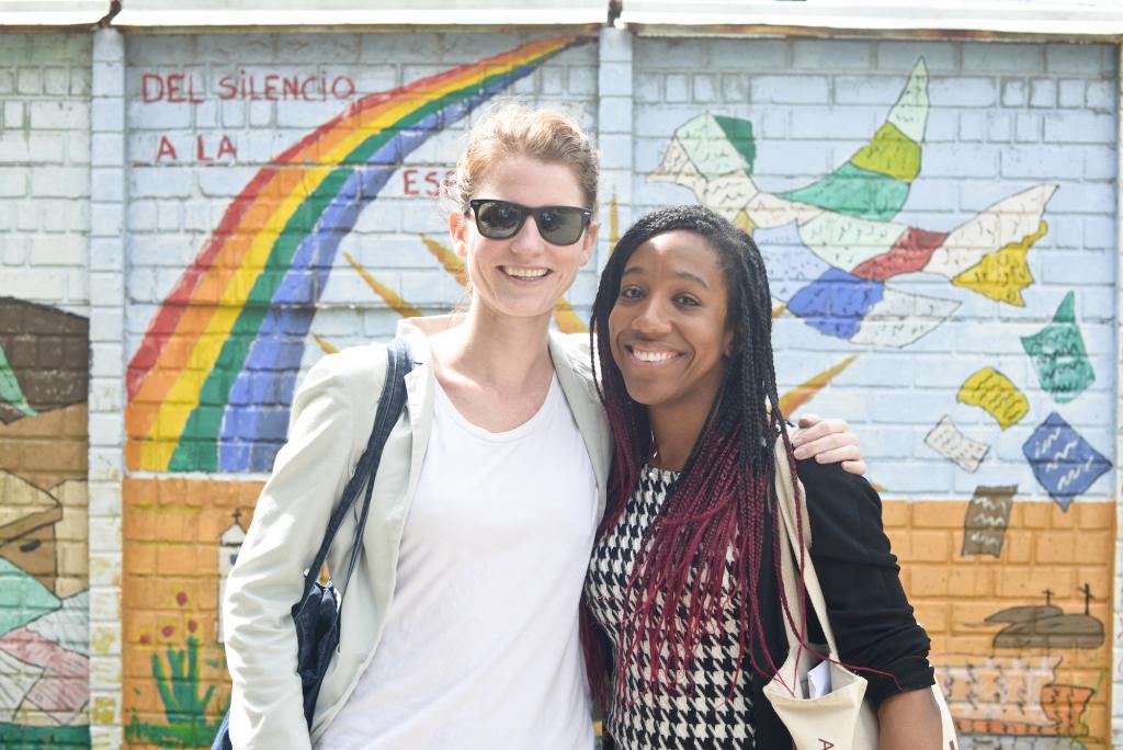 Ashley Peoples (left) and Abisola Omotayo (right) standing in front of a mural at the National Police Historical Archive in Guatemala City. The Archive houses 80 million documents detailing police actions during the civil war. Photography by Samer Muscati.